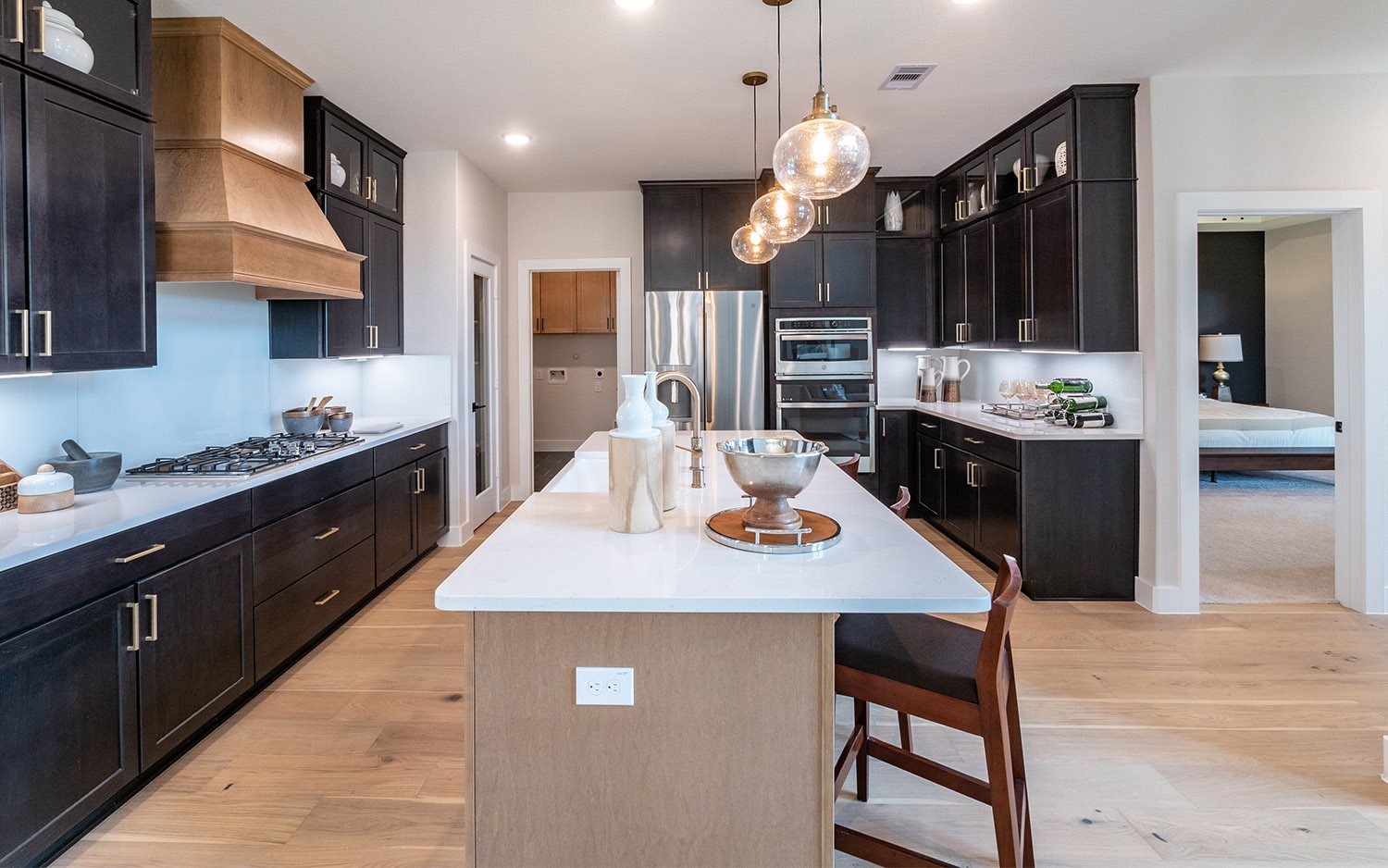 830 Aspen Bluffs Road Crosby, TX 77532 - Photo 5 of 23 a kitchen with a stove a kitchen island a sink and cabinets