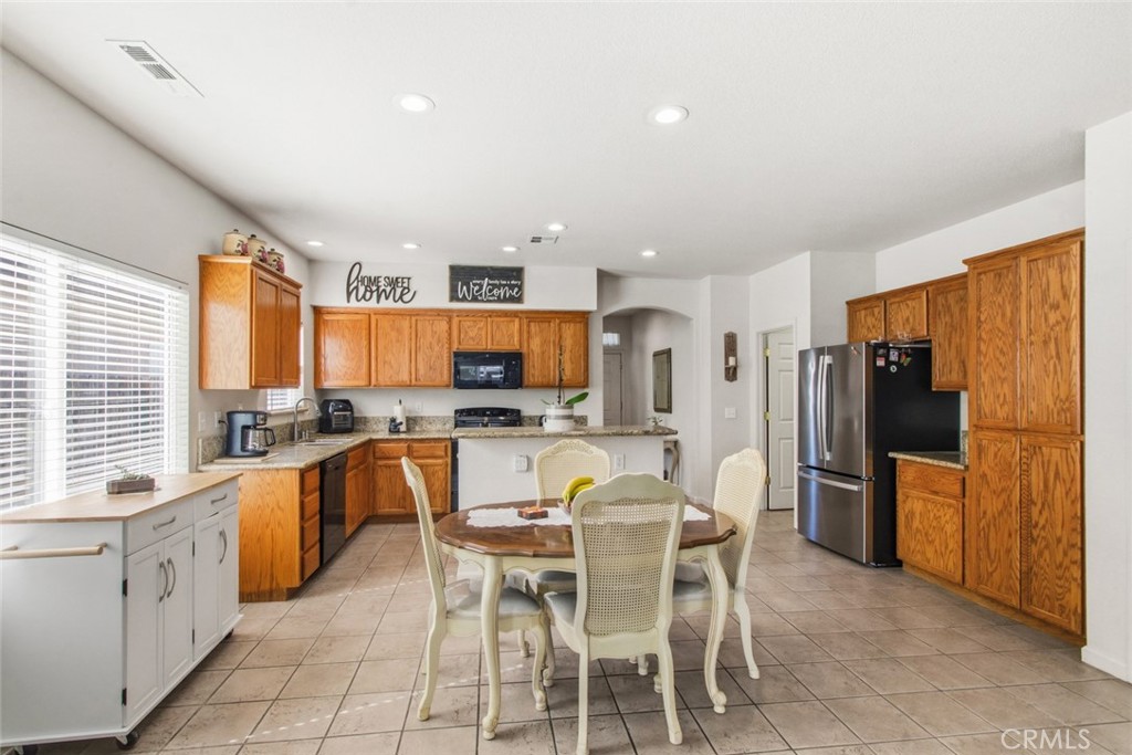 2408 Snap Dragon Court Modesto, CA 95355 - Photo 16 of 37 a large kitchen with a table and chairs