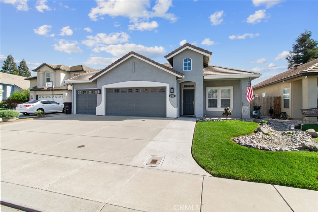 2408 Snap Dragon Court Modesto, CA 95355 - Photo 2 of 37 a front view of a house with a garden and plants