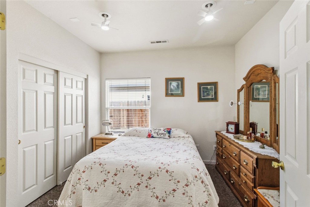 2408 Snap Dragon Court Modesto, CA 95355 - Photo 22 of 37 a bedroom with a bed and a dresser in it