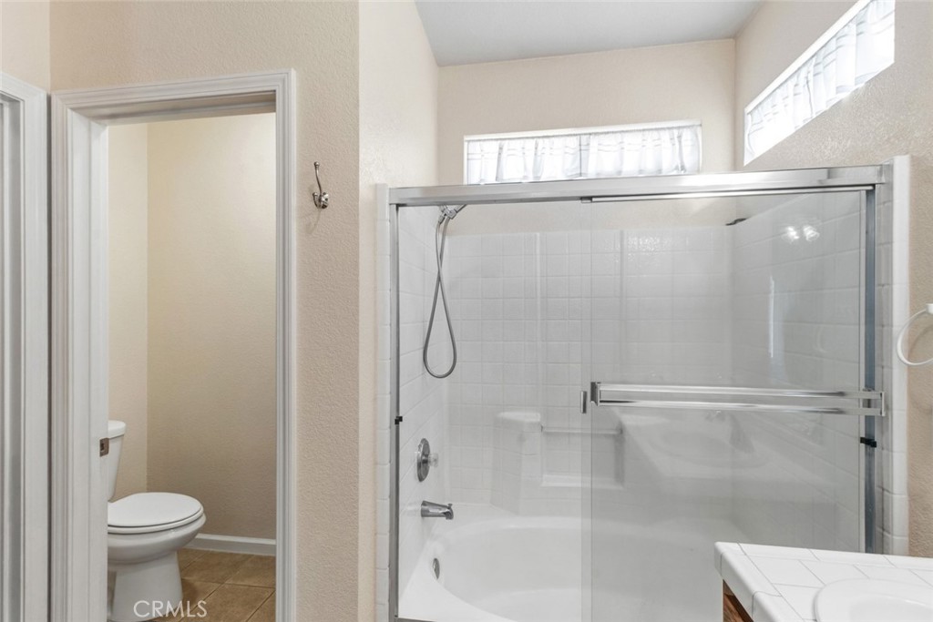 2408 Snap Dragon Court Modesto, CA 95355 - Photo 28 of 37 a bathroom with a shower and a toilet