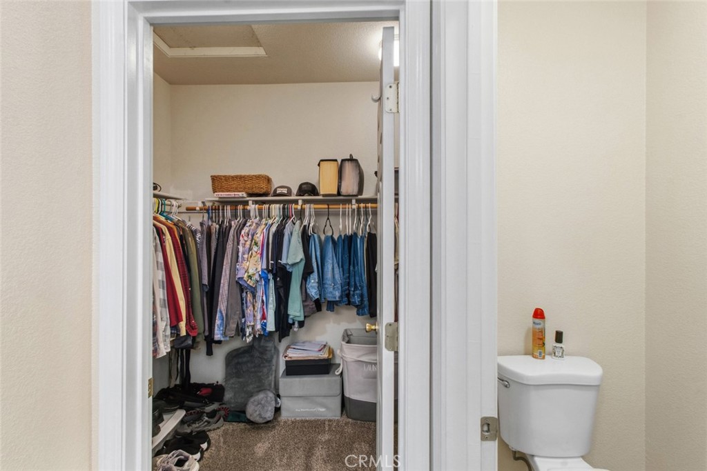 2408 Snap Dragon Court Modesto, CA 95355 - Photo 29 of 37 a view of walk in closet with clothes and shoes