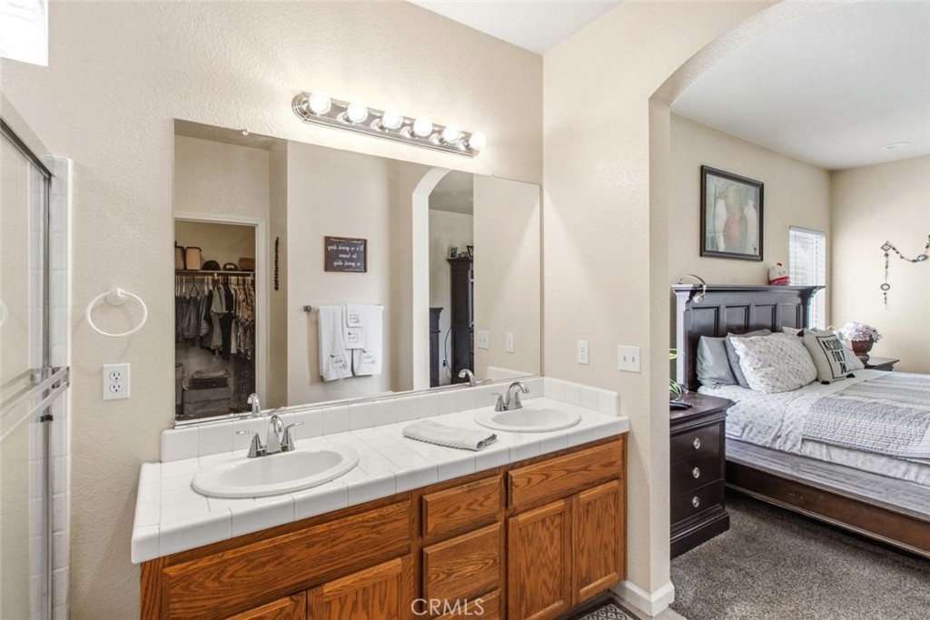 2408 Snap Dragon Court Modesto, CA 95355 - Photo 30 of 37 a en suite bathroom with a double vanity sink double and a mirror