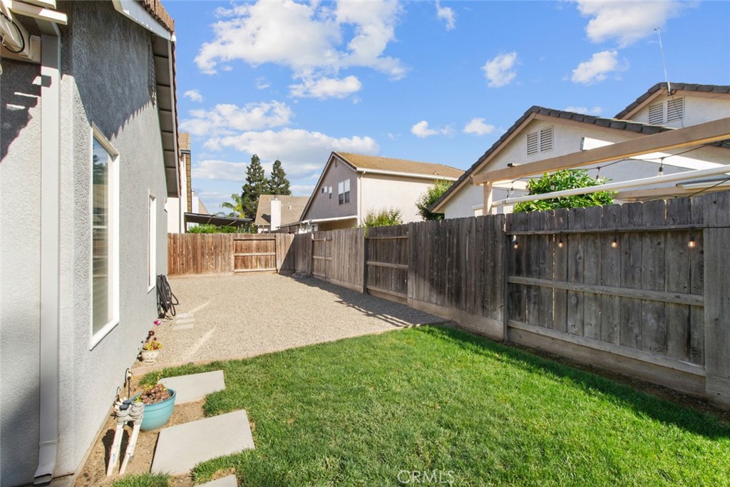 2408 Snap Dragon Court Modesto, CA 95355 - Photo 32 of 37 a backyard of a house with wooden floor and fence