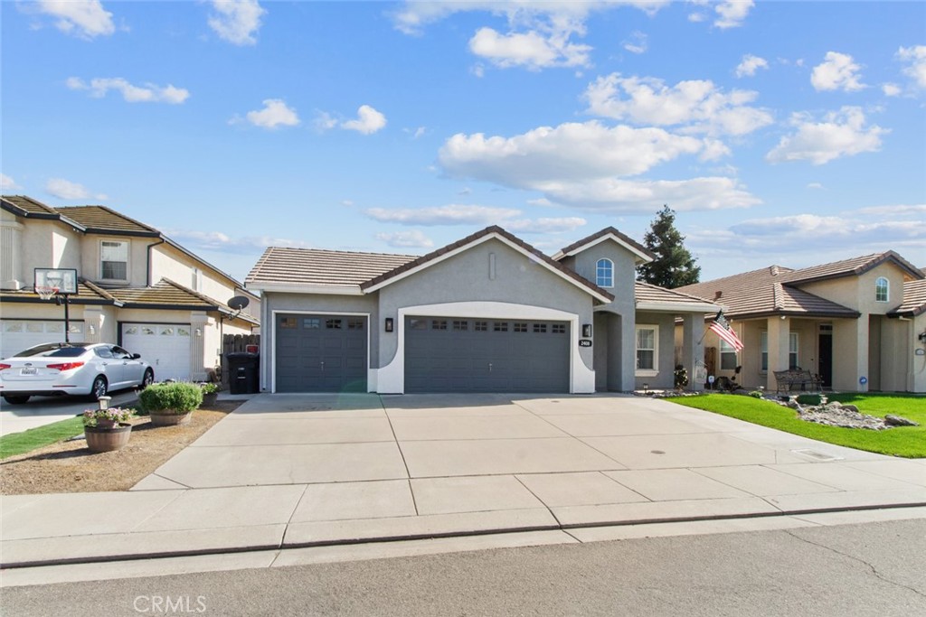 2408 Snap Dragon Court Modesto, CA 95355 - Photo 5 of 37 a front view of a house with a yard and garage