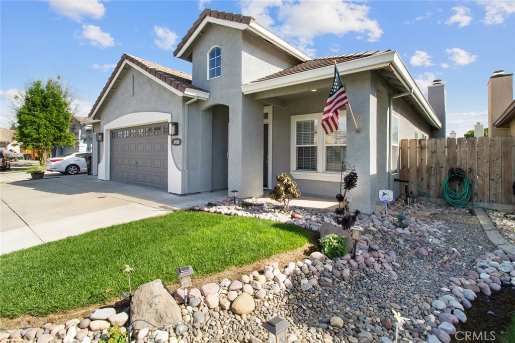 2408 Snap Dragon Court Modesto, CA 95355 - Photo 7 of 37 a front view of house with a garden and patio