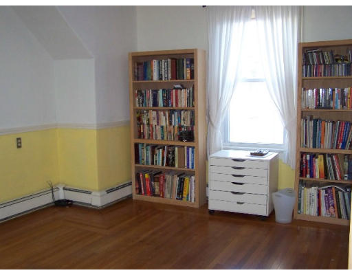 29 Spring Street Woonsocket, RI 02895 - Photo 11 of 15 a room with bookshelf and a wooden floor