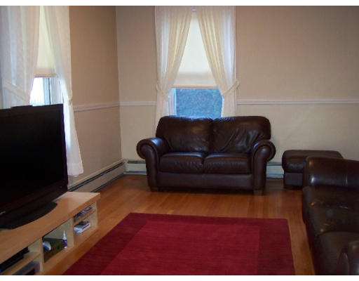 29 Spring Street Woonsocket, RI 02895 - Photo 2 of 15 a living room with furniture and a flat screen tv