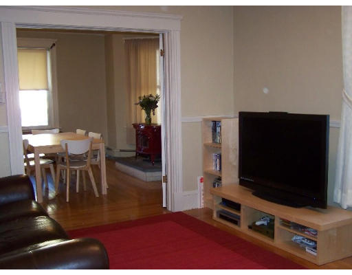 29 Spring Street Woonsocket, RI 02895 - Photo 3 of 15 a living room with dining room and flat screen tv