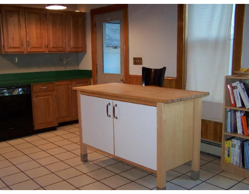29 Spring Street Woonsocket, RI 02895 - Photo 7 of 15 a kitchen with stainless steel appliances granite countertop a refrigerator and a cabinets