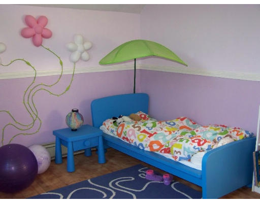 29 Spring Street Woonsocket, RI 02895 - Photo 10 of 15 a bedroom with a bed and chandelier