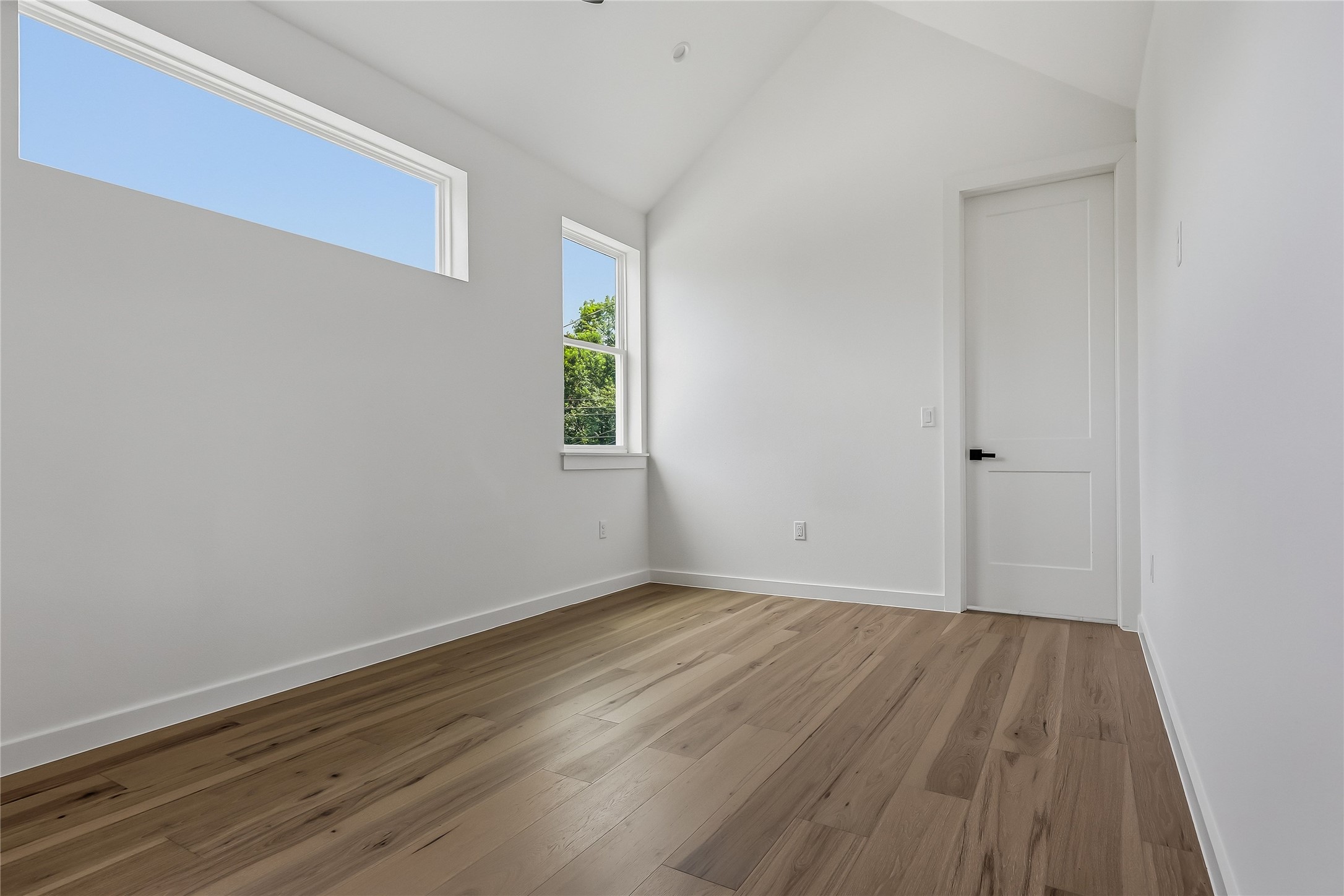 6809 Porter Street, Unit 1 Austin, TX 78741 - Photo 31 of 40 Upstairs secondary bedroom, engineered wood flooring.