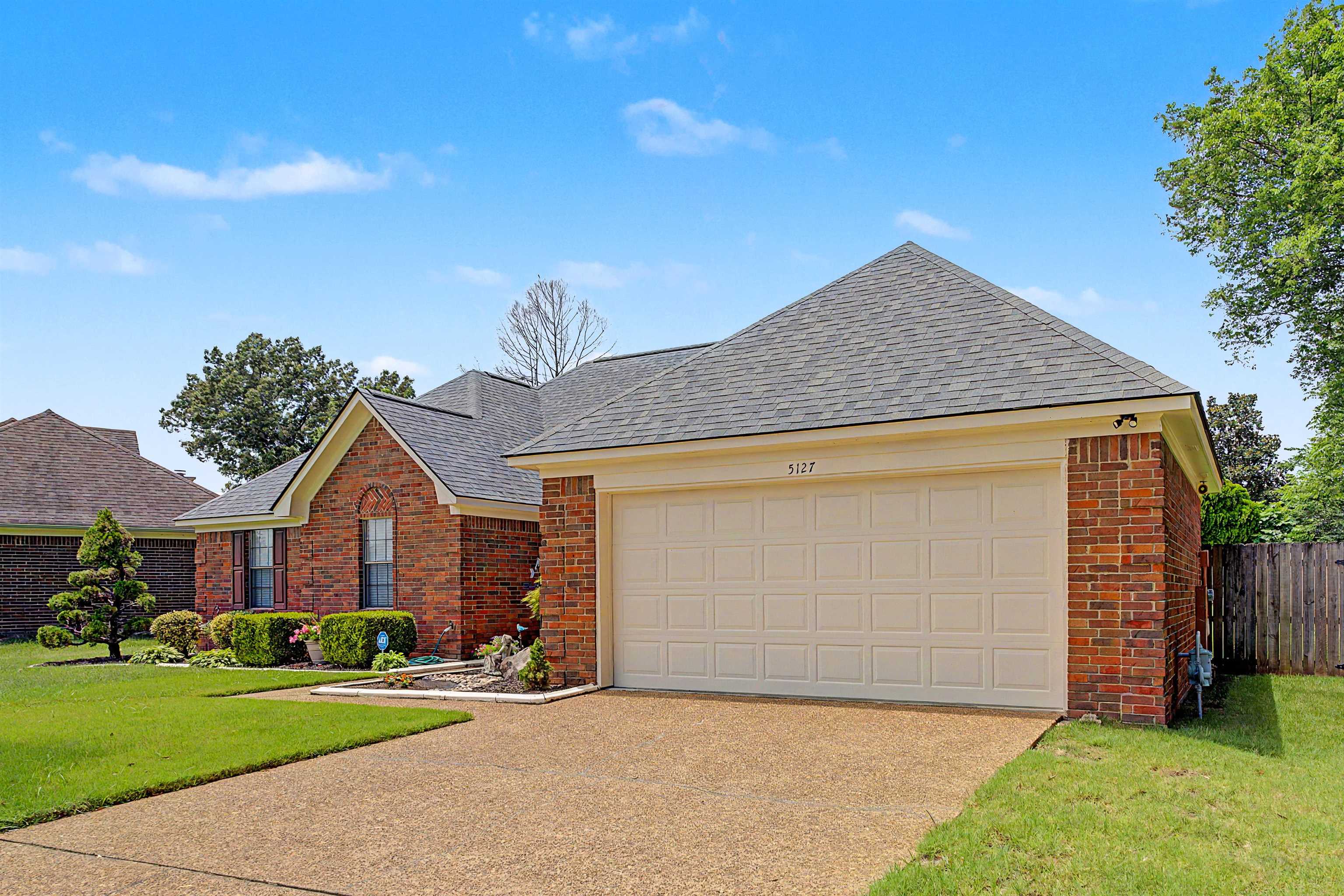 5127 Overview Ridge Memphis, TN 38141 - Photo 3 of 36 Brick exterior with a gabled roof and attached two-car garage