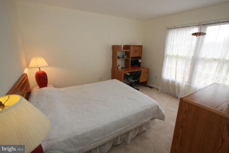 10 Autumn Ridge Court Silver Spring, MD 20906 - Photo 2 of 23 a bedroom with a bed and a window