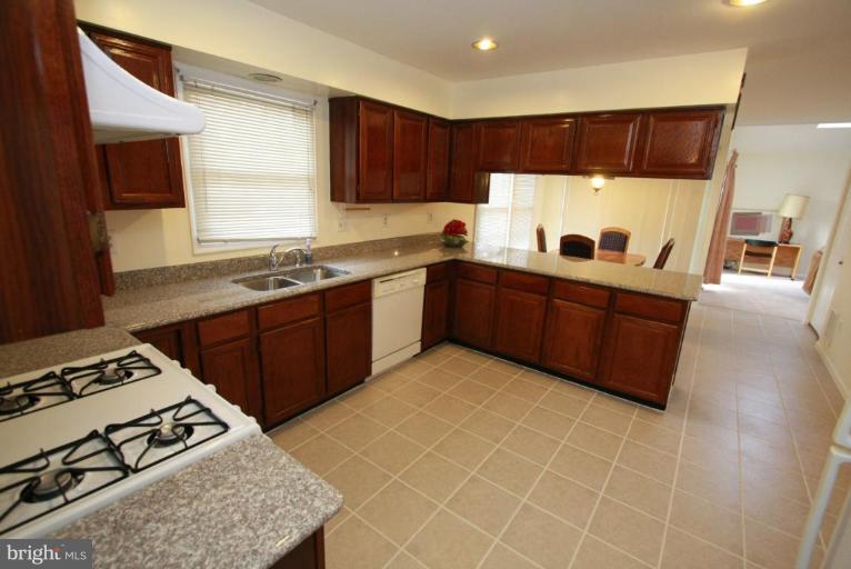 10 Autumn Ridge Court Silver Spring, MD 20906 - Photo 12 of 23 a kitchen with stainless steel appliances granite countertop a sink stove and refrigerator