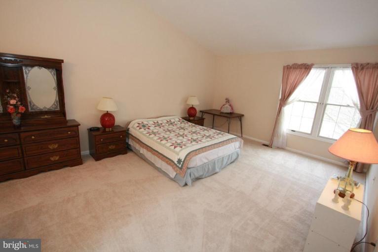 10 Autumn Ridge Court Silver Spring, MD 20906 - Photo 21 of 23 a bedroom with a bed and a dresser in it