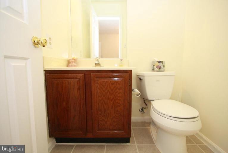 10 Autumn Ridge Court Silver Spring, MD 20906 - Photo 22 of 23 a bathroom with a toilet a sink and mirror