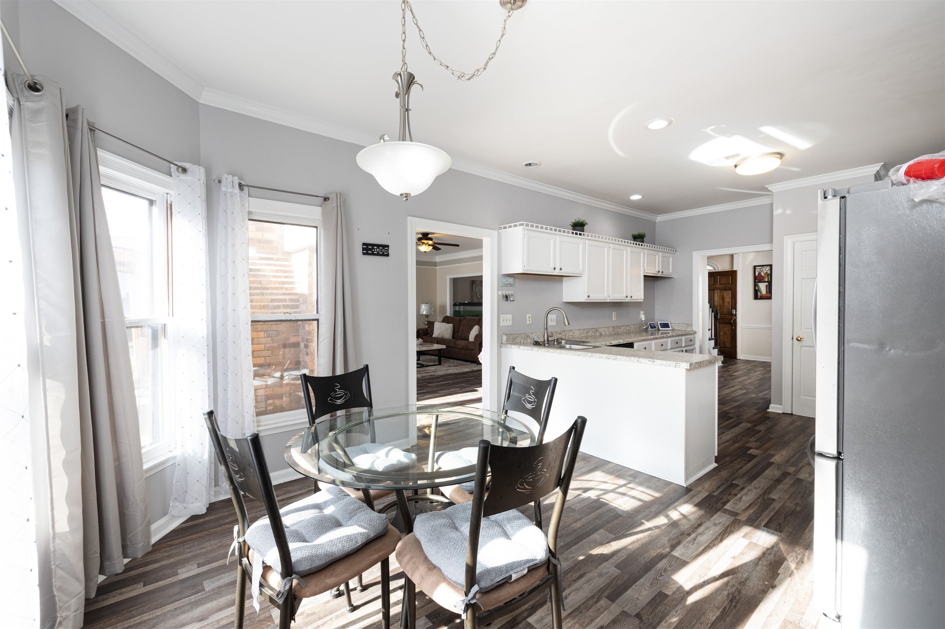 6801 Stout Road Memphis, TN 38119 - Photo 11 of 25 a dining room with stainless steel appliances kitchen island granite countertop a dining table chairs and a refrigerator