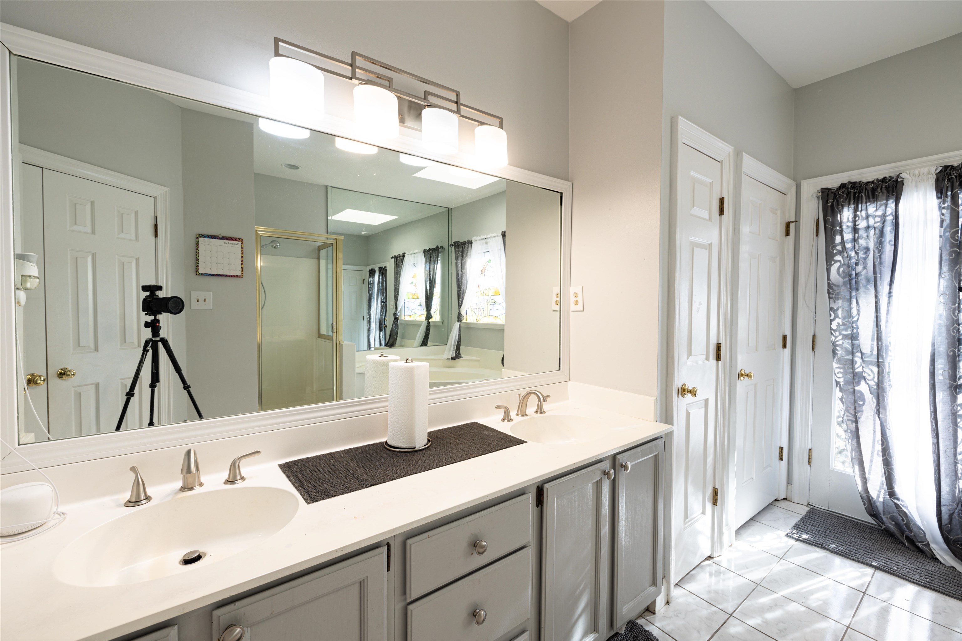 6801 Stout Road Memphis, TN 38119 - Photo 16 of 25 a bathroom with a double vanity sink mirror and next to a window