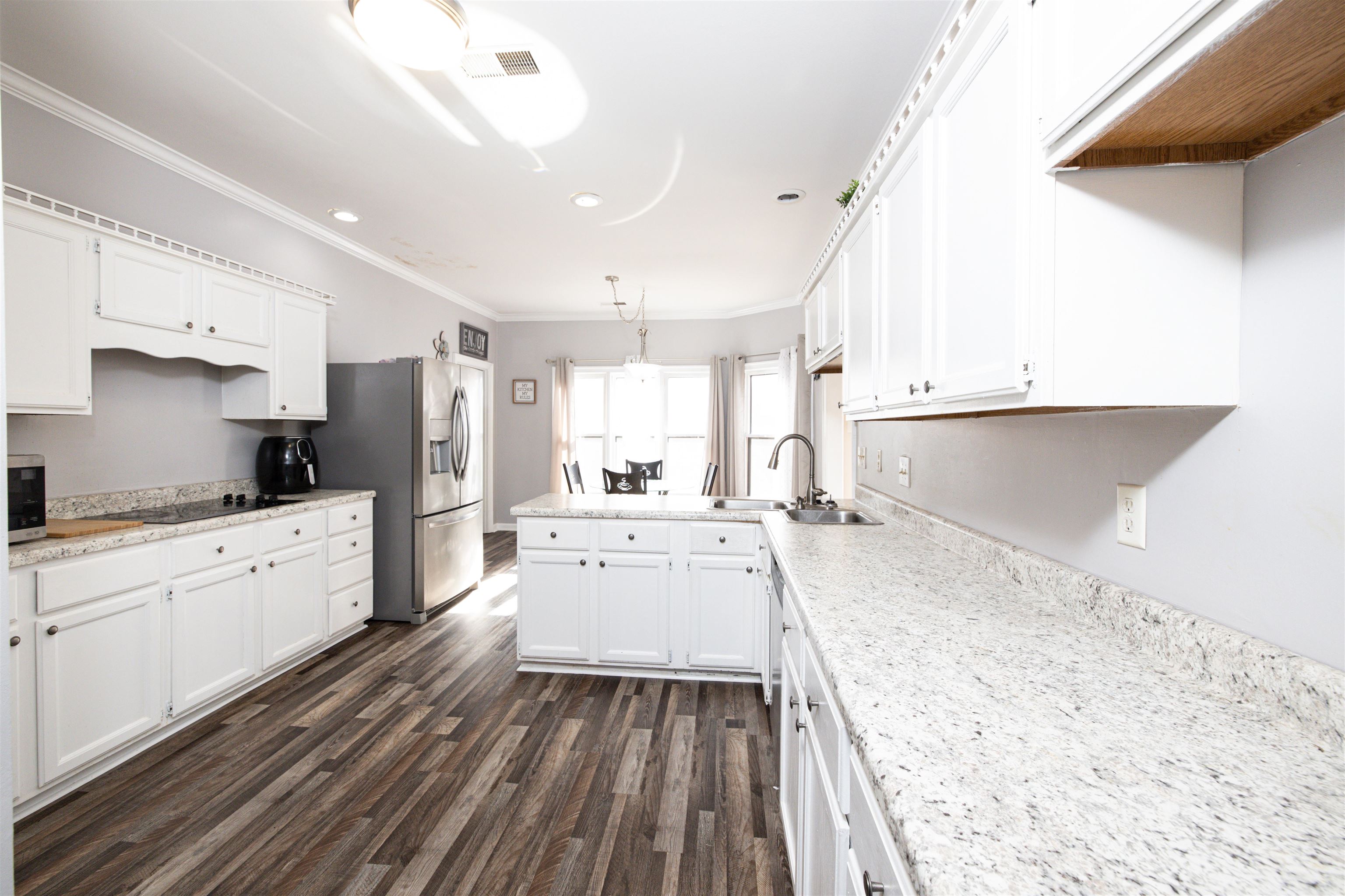 6801 Stout Road Memphis, TN 38119 - Photo 10 of 25 a large kitchen with a lot of counter space and wooden floor