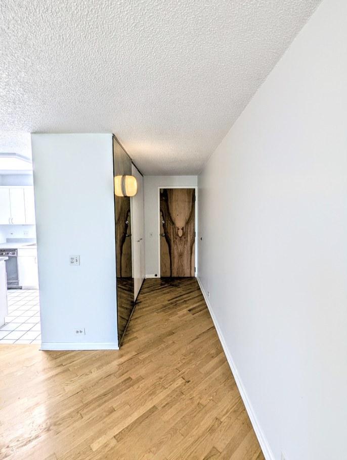 2555 Gross Point Road, Unit 407 Evanston, IL 60201 - Photo 4 of 10 a view of a hallway with wooden floor and entryway