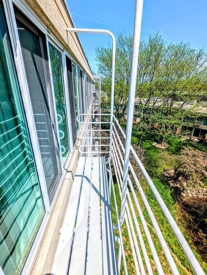 2555 Gross Point Road, Unit 407 Evanston, IL 60201 - Photo 8 of 10 a view of balcony with wooden floor and fence