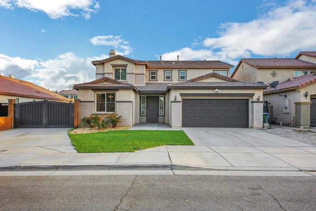 a front view of a house with a garden and plants
