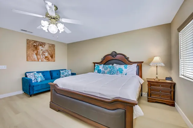 a bedroom with two beds and a window