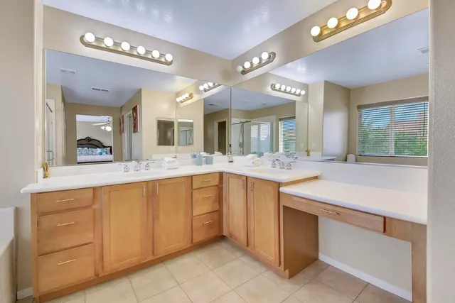 a bedroom with two beds and a chandelier