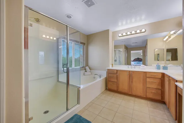 a bedroom with a bed mirror and window