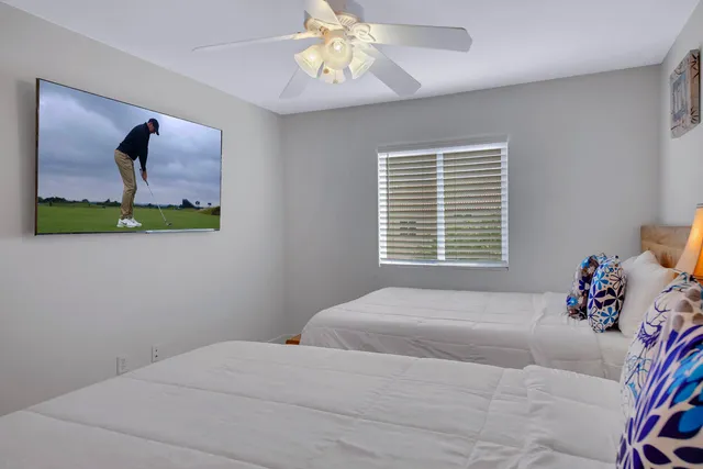 a bedroom with a bed and a painting on the wall