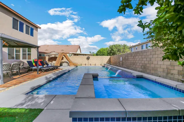 a living room with furniture and a ceiling fan