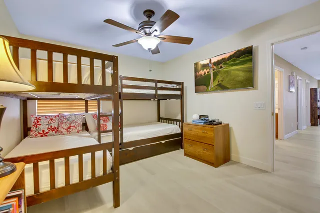 a living room with furniture and a book shelf