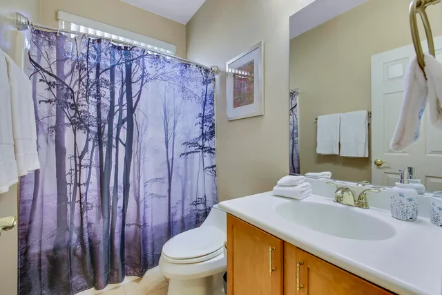 a view of a house with swimming pool lawn chairs and a yard