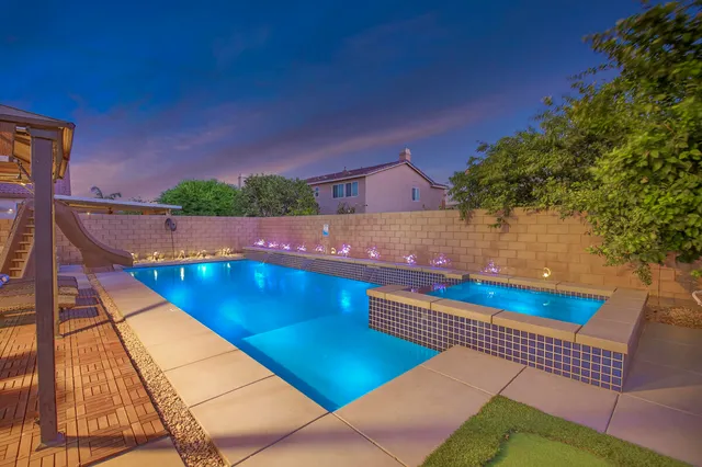 a living room with furniture a flat screen tv and a window