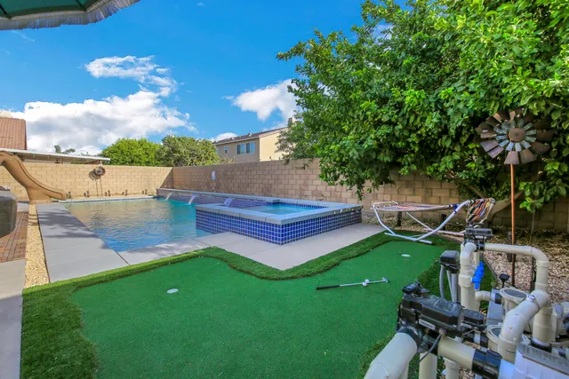 a view of a house with swimming pool having outdoor seating