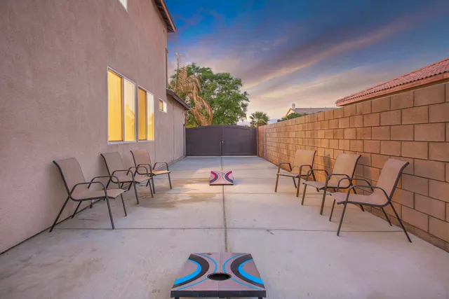 a patio with a table and chairs under an umbrella