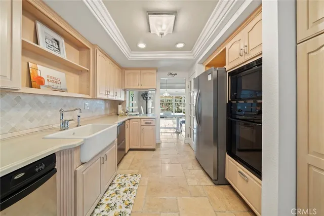 a kitchen with stainless steel appliances granite countertop a refrigerator and a sink