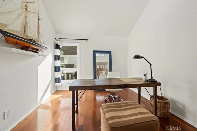 a view of a balcony with furniture and front door