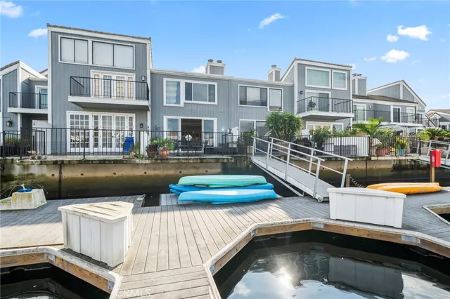 a view of a house with pool and chairs