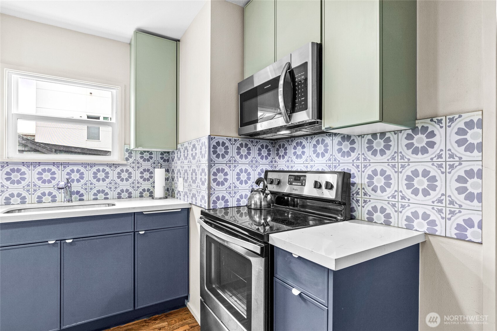 4431 Southwest Admiral Way Seattle, WA 98116 - Photo 9 of 25 a kitchen with a stove and a sink