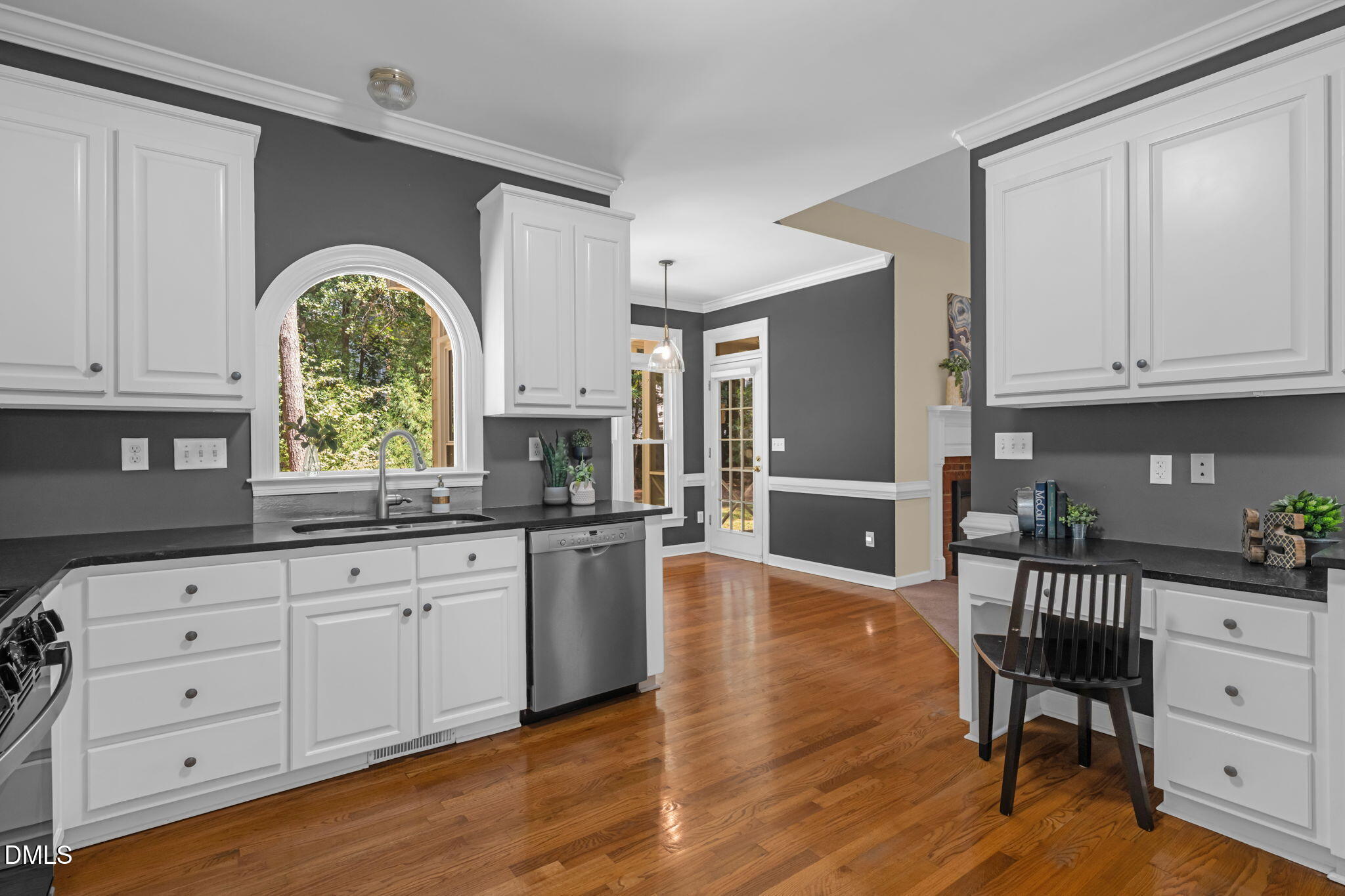 5309 Shoreline Court Holly Springs, NC 27540 - Photo 11 of 46 a kitchen with stainless steel appliances granite countertop a refrigerator a stove a sink and white cabinets with wooden floor