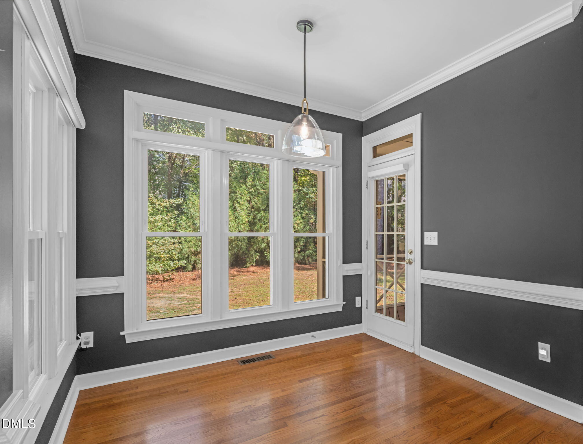 5309 Shoreline Court Holly Springs, NC 27540 - Photo 14 of 46 a view of an empty room with window and hardwood floor