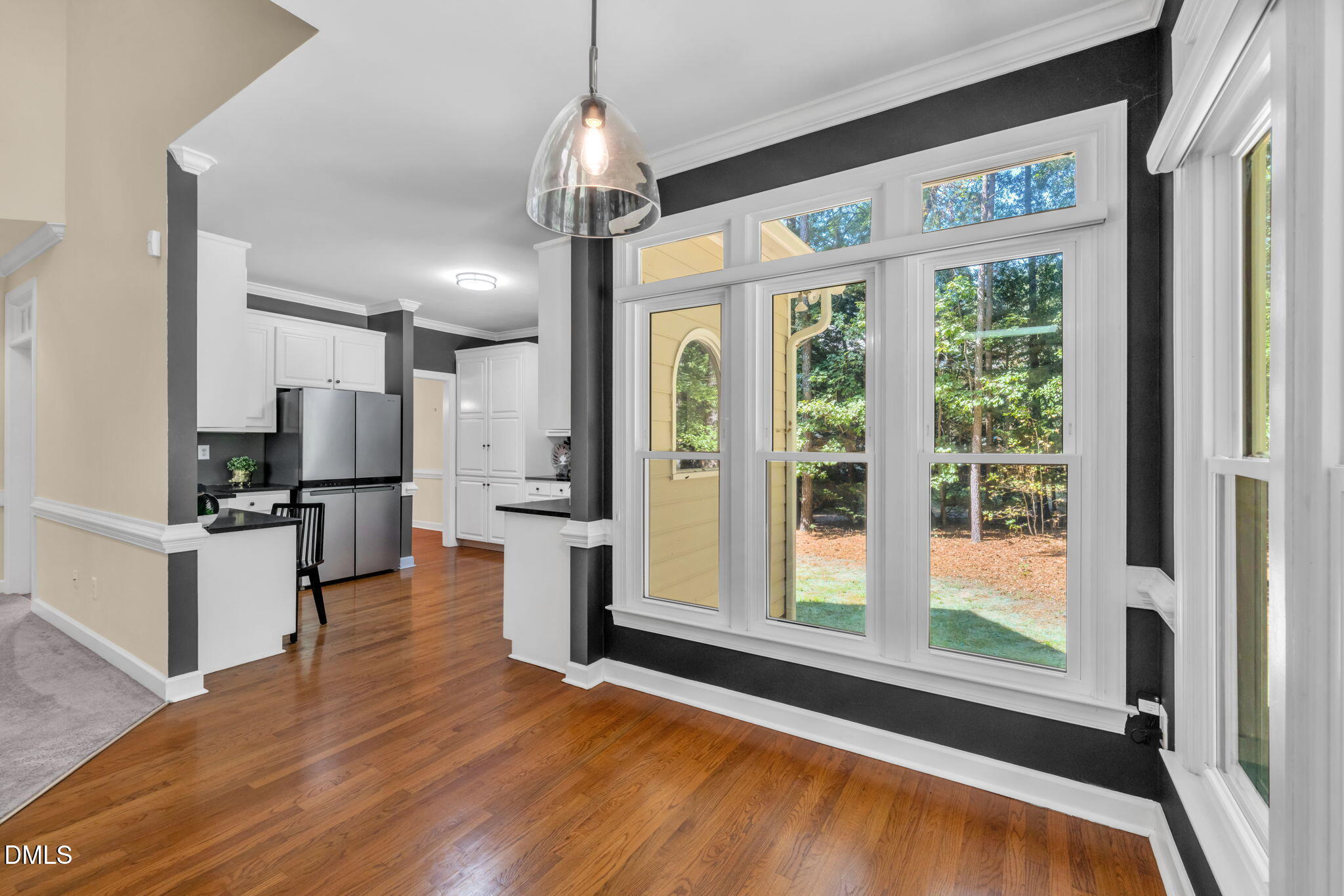5309 Shoreline Court Holly Springs, NC 27540 - Photo 15 of 46 a open kitchen with stainless steel appliances granite countertop a refrigerator oven stove a island and couches with wooden floor