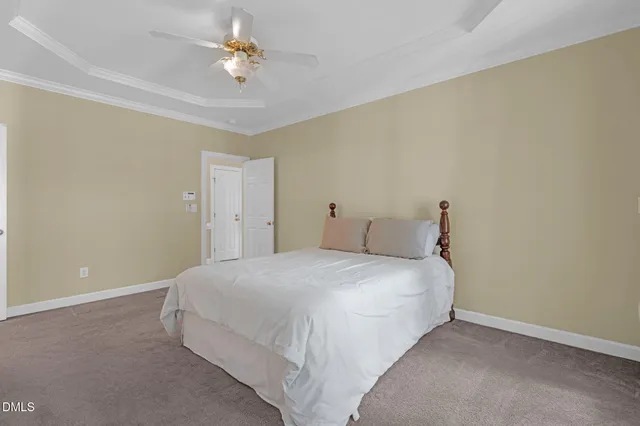 a bedroom with a bed and a ceiling fan