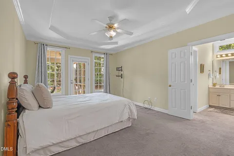 a bedroom with a large bed and a chandelier