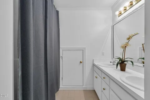 a bathroom with a sink and mirror with window