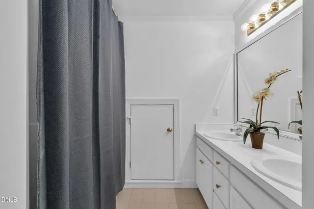 a bathroom with a sink and mirror with window