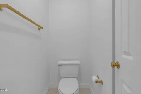 a white toilet sitting next to a sink