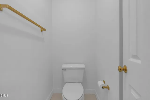 a white toilet sitting next to a sink